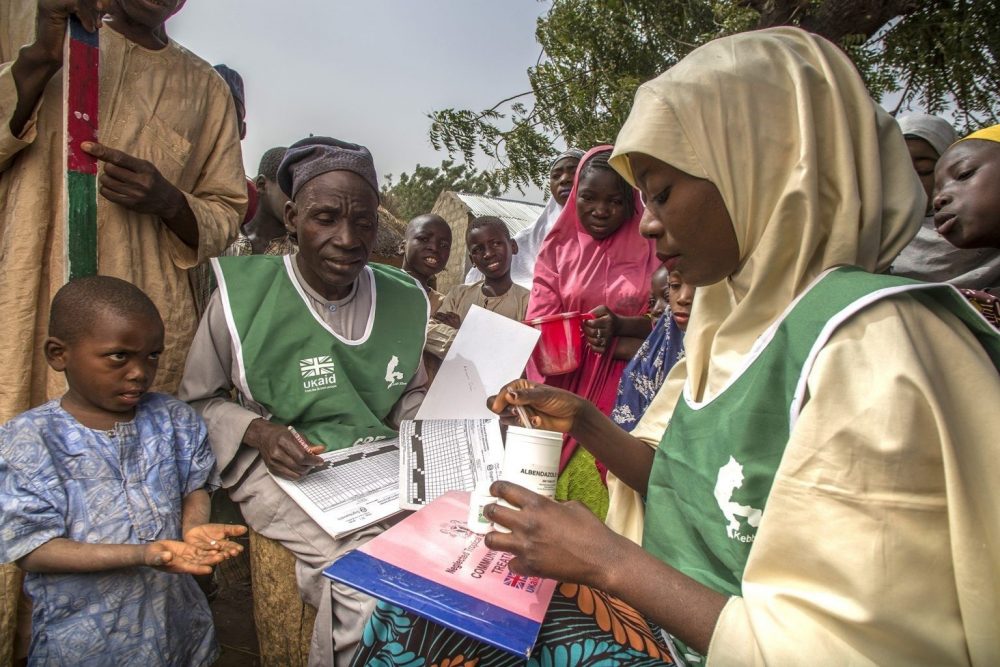 Photo of a woman distributing medication in Nigeria