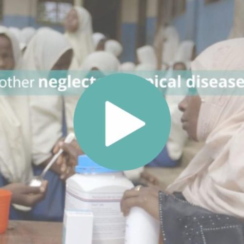 screen shot of a video showing a boy receiving medicine from a woman