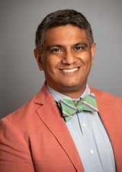 photo of a man wearing a green bow tie